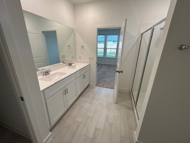 20811 Solaro Summit Trail Tomball, TX 77377 - Photo 8 of 19 a bathroom with a sink a mirror and a shower