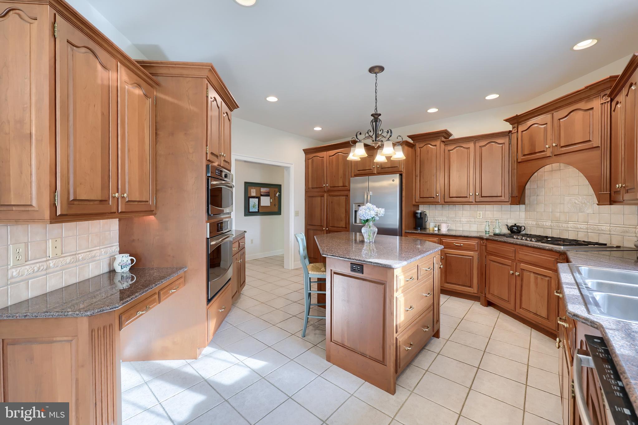 339 Harvest Drive Lititz, PA 17543 - Photo 21 of 69 a kitchen with stainless steel appliances granite countertop a stove top oven a sink dishwasher and cabinets with wooden floor