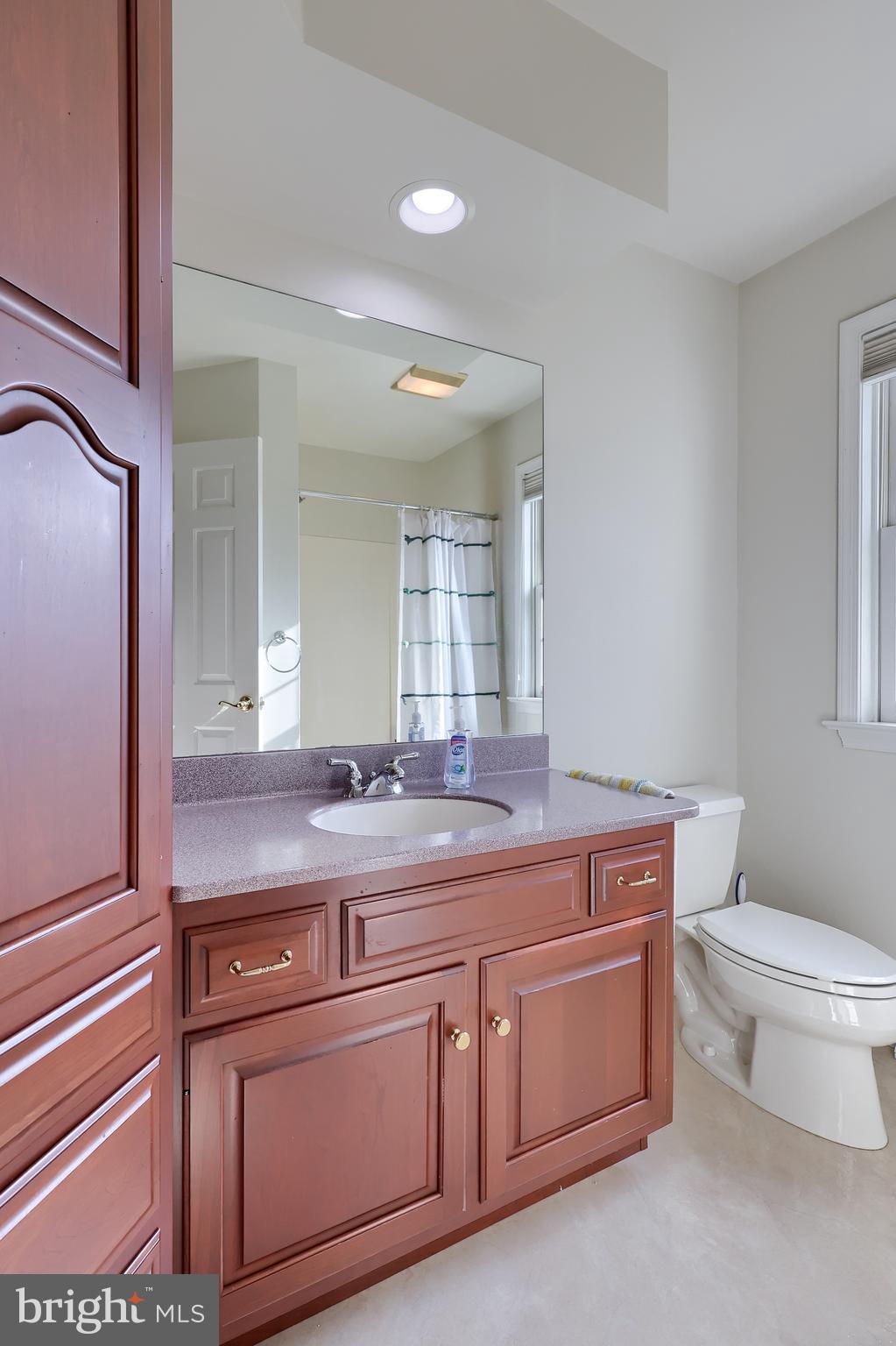 339 Harvest Drive Lititz, PA 17543 - Photo 49 of 69 a bathroom with a granite countertop toilet a sink and a mirror