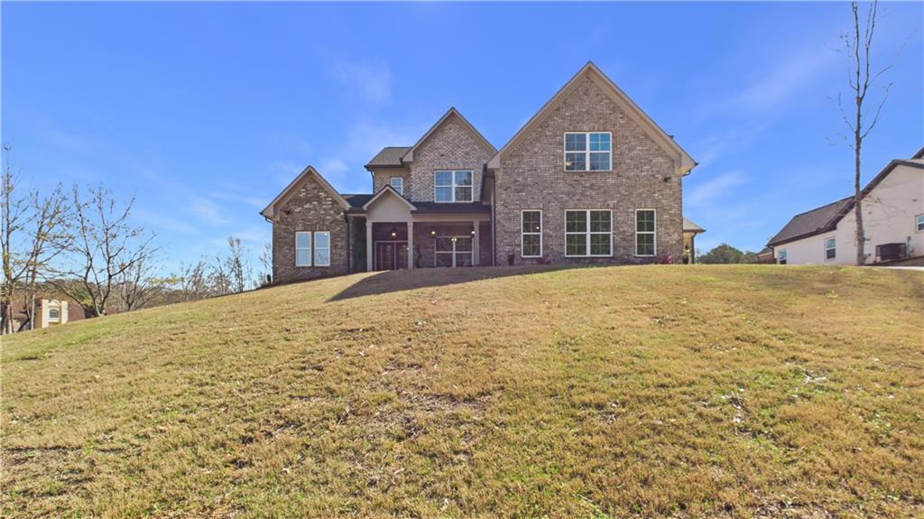 106 Neal Point Atlanta, GA 30349 - Photo 1 of 19 a front view of a house with a yard