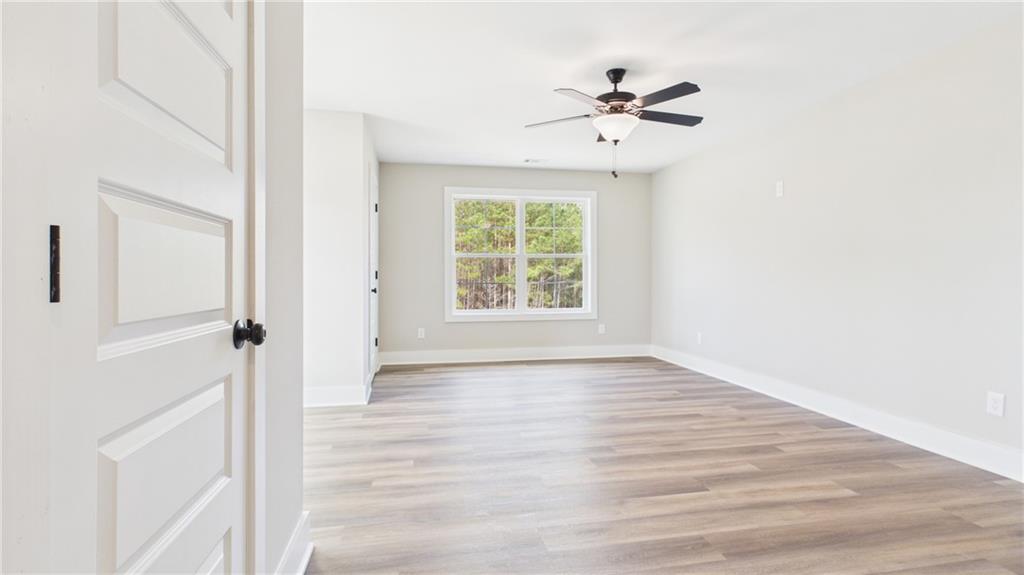 106 Neal Point Atlanta, GA 30349 - Photo 14 of 19 a view of an empty room with wooden floor and a window