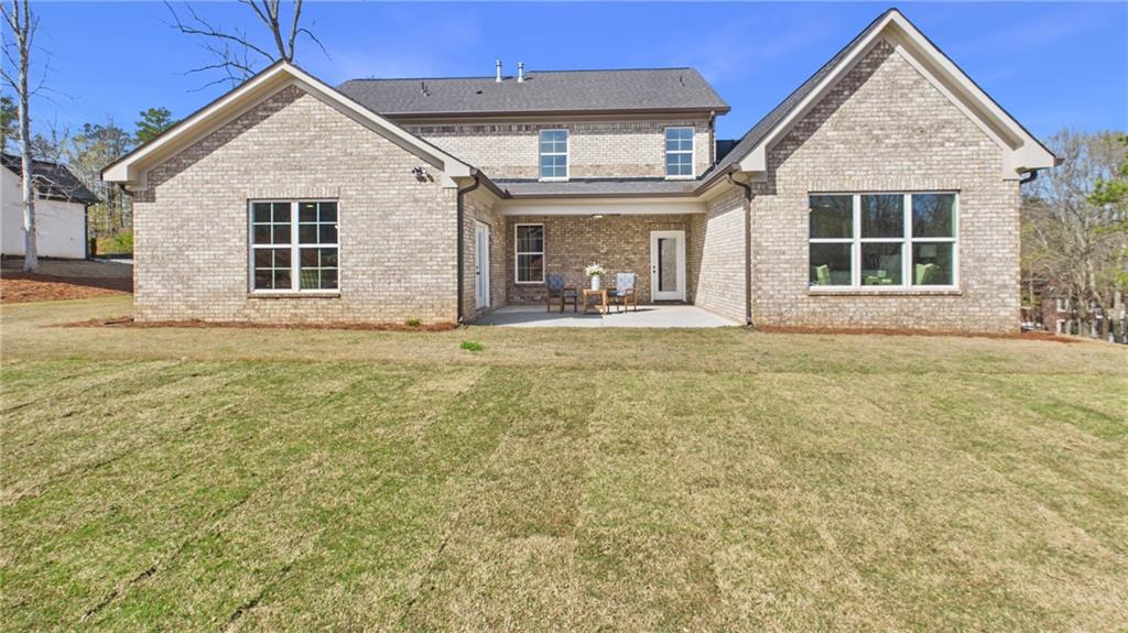 106 Neal Point Atlanta, GA 30349 - Photo 17 of 19 a front view of a house with a garden