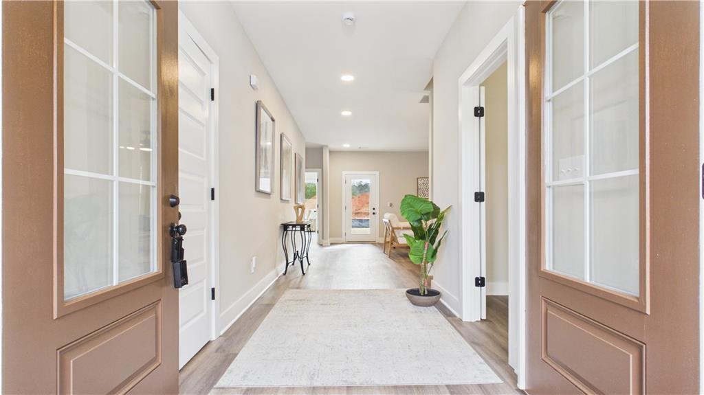 106 Neal Point Atlanta, GA 30349 - Photo 3 of 19 a hallway with white doors wooden floor and glass door