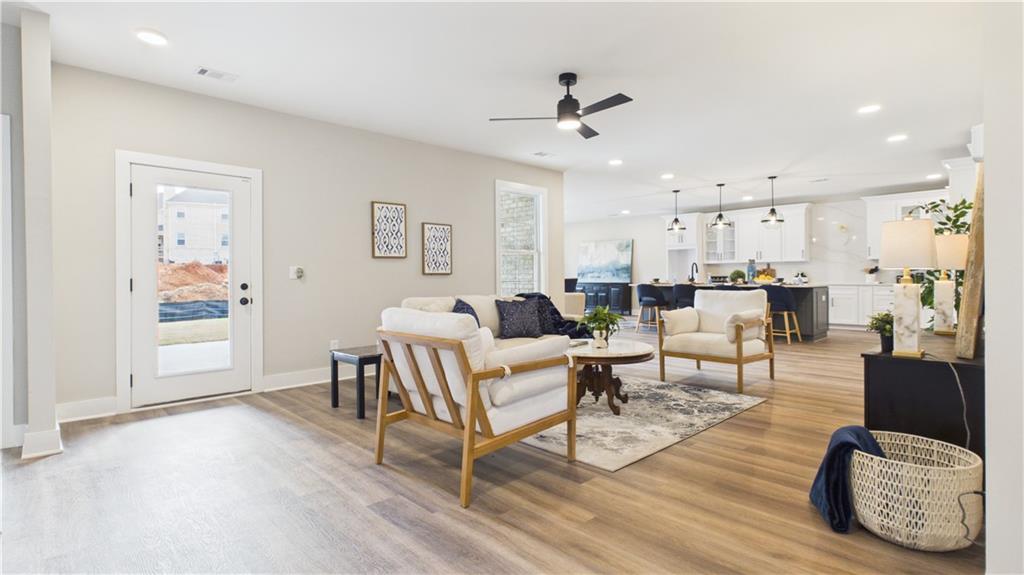 106 Neal Point Atlanta, GA 30349 - Photo 5 of 19 a living room with furniture and a wooden floor