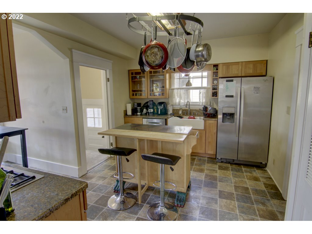 1926 Alder Street Eugene, OR 97405 - Photo 14 of 32 a kitchen with stainless steel appliances kitchen island granite countertop a refrigerator and a stove