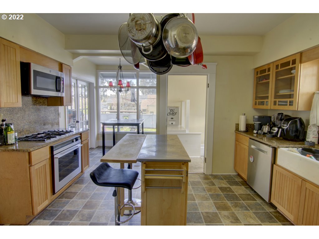 1926 Alder Street Eugene, OR 97405 - Photo 15 of 32 a kitchen with stainless steel appliances granite countertop a stove a sink and a microwave