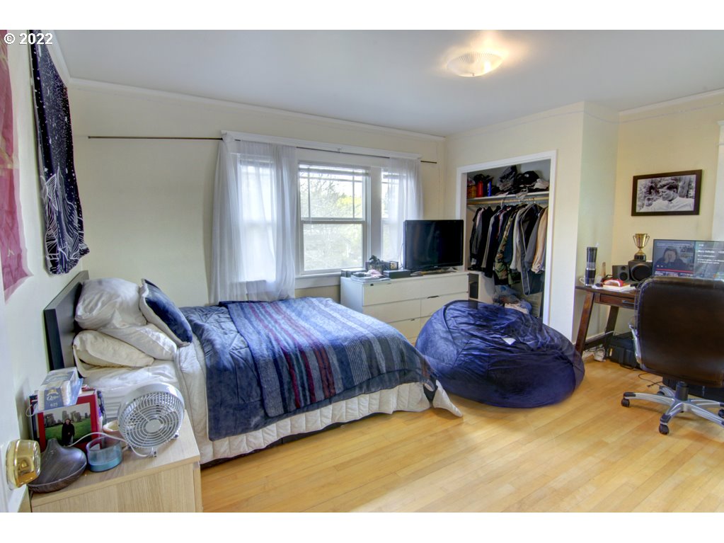 1926 Alder Street Eugene, OR 97405 - Photo 21 of 32 a spacious bedroom with a bed and a window