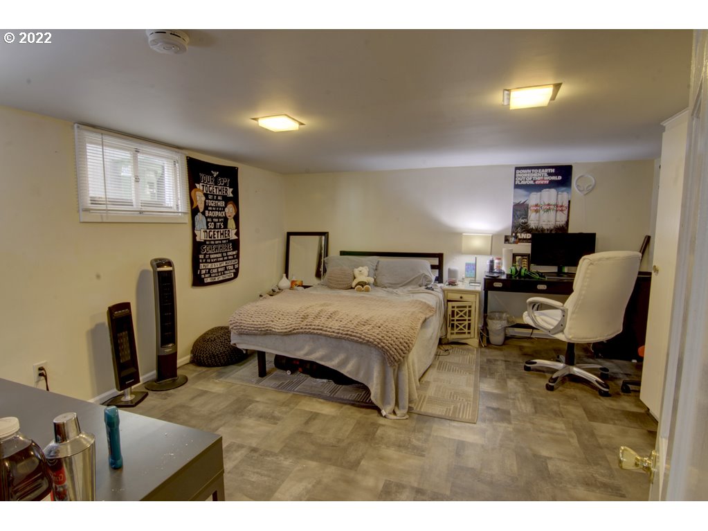 1926 Alder Street Eugene, OR 97405 - Photo 25 of 32 a bedroom with a bed a table and chair
