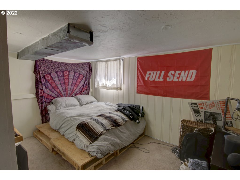 1926 Alder Street Eugene, OR 97405 - Photo 26 of 32 a bedroom with a bed and a television