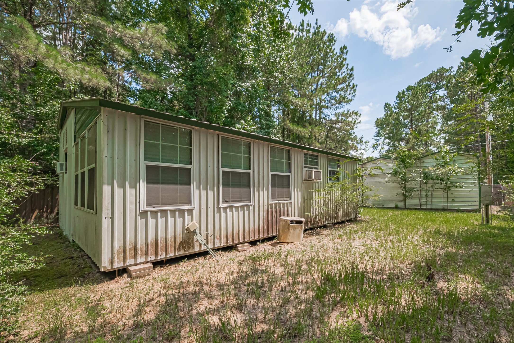 477 Canadian Drive Trinity, TX 75862 - Photo 4 of 11 Cozy façade with leafy surroundings, set back on a low-maintenance lot.