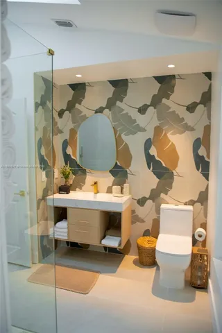 a bedroom with bed and wall painting