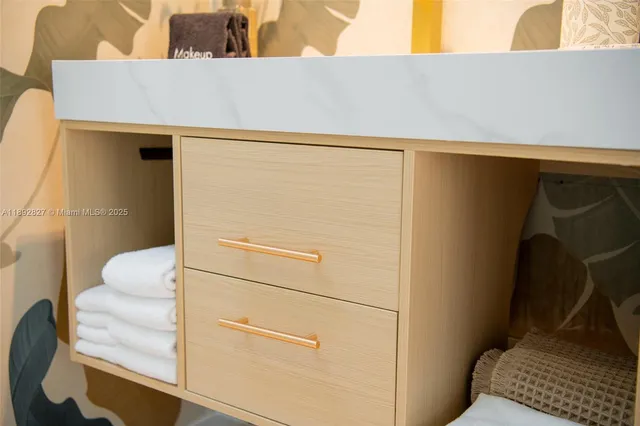 a bedroom with a bed tv and a chair