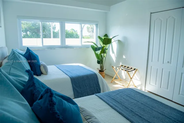 a bedroom with bed and glass window