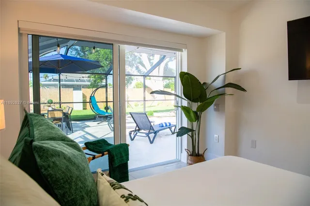 a living room with a table and a mirror