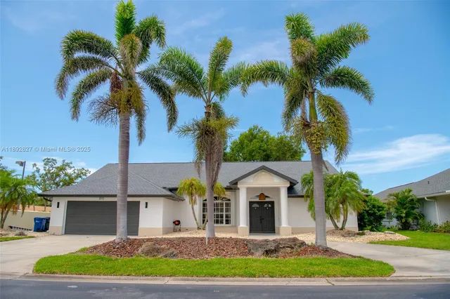 an aerial view of a house with garden space and houses