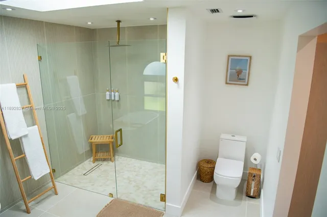 a living room with furniture a flat screen tv and a large window