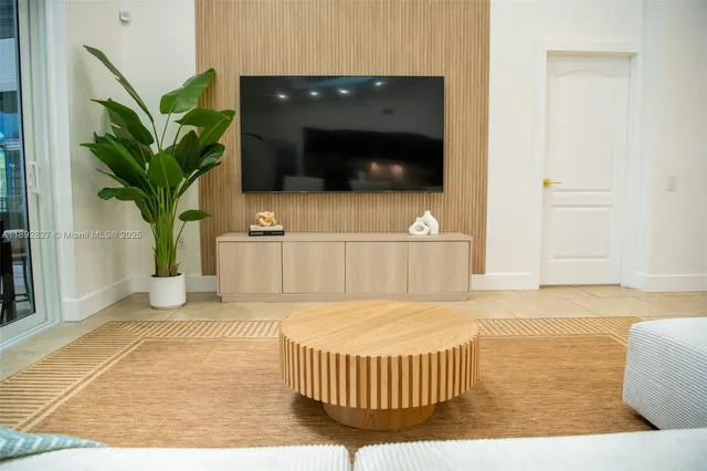 a view of a patio with a table chairs and a fire pit
