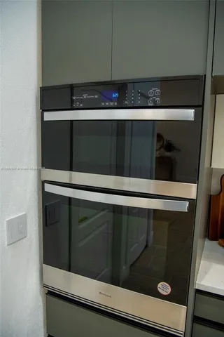 a dining table with chairs and window