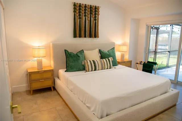 a bathroom with a sink mirror toilet and next to a window