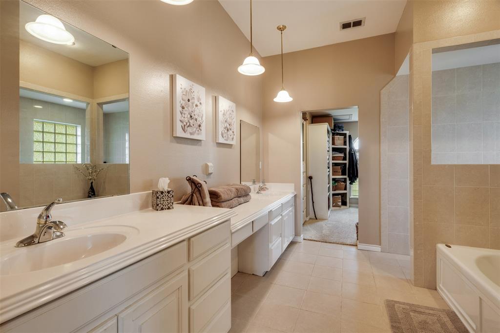6101 Kovarik Road Wichita Falls, TX 76310 - Photo 12 of 40 a bathroom with a double vanity sink a toilet and a mirror