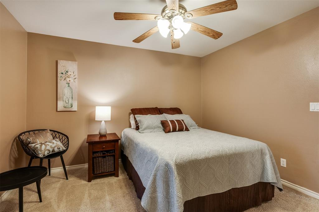 6101 Kovarik Road Wichita Falls, TX 76310 - Photo 13 of 40 a bedroom with a bed and a chandelier