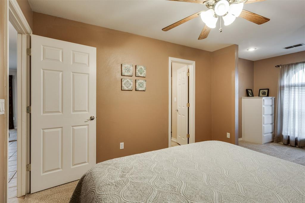 6101 Kovarik Road Wichita Falls, TX 76310 - Photo 14 of 40 a bedroom with a bed and a chandelier