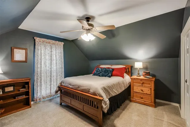 a bedroom with a bed and a ceiling fan