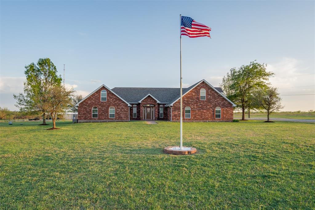 6101 Kovarik Road Wichita Falls, TX 76310 - Photo 2 of 40 a flag is sitting in the middle of a field