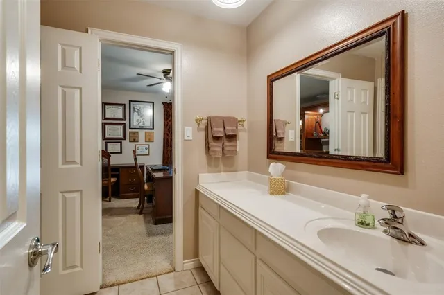 a en suite bathroom with a sink double vanity and a mirror