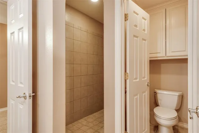 a bathroom with a granite countertop toilet and a shower