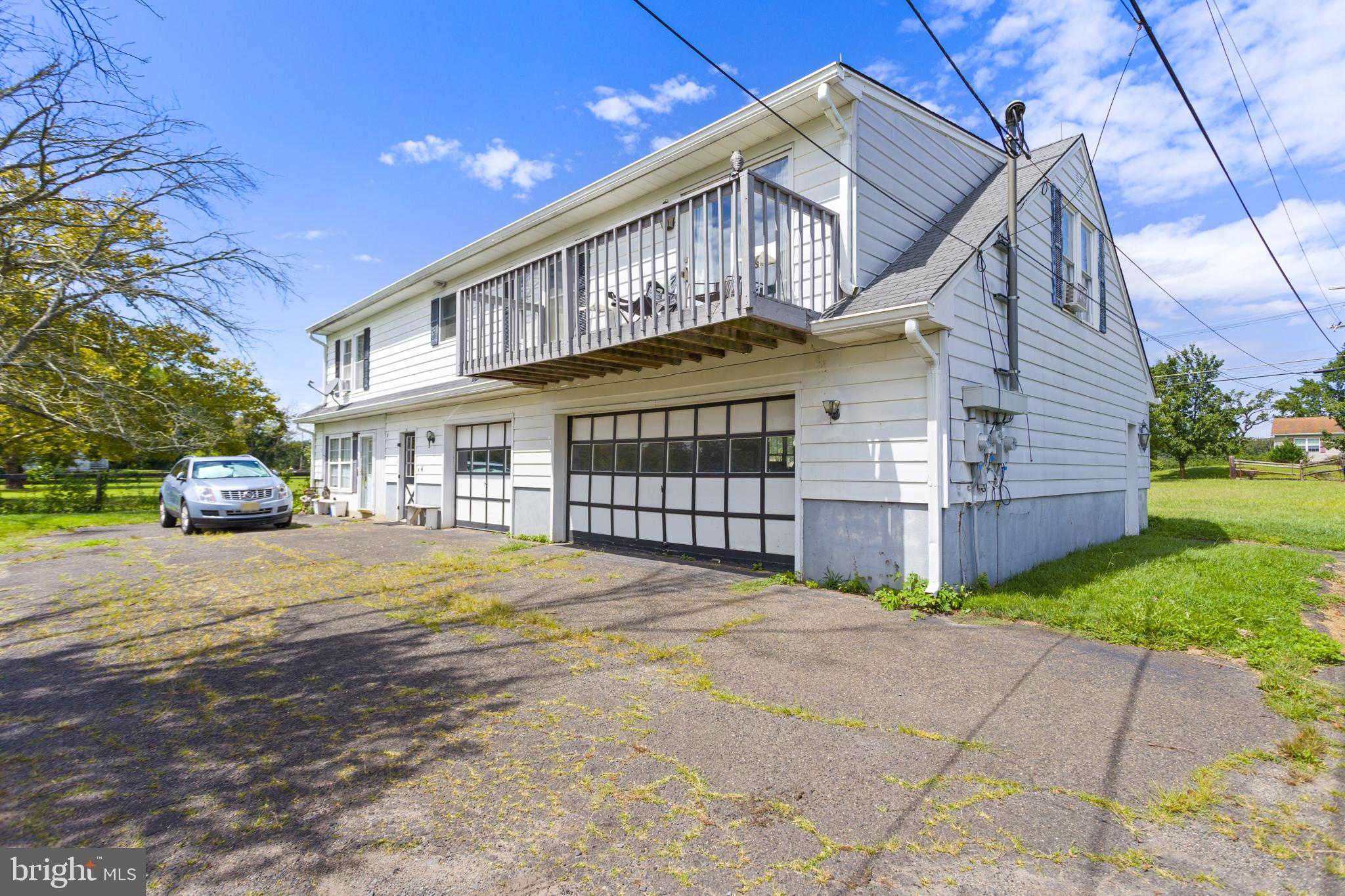 a front view of a house with a garden and deck