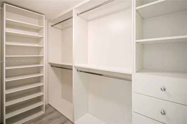 a view of walk in closet with empty racks