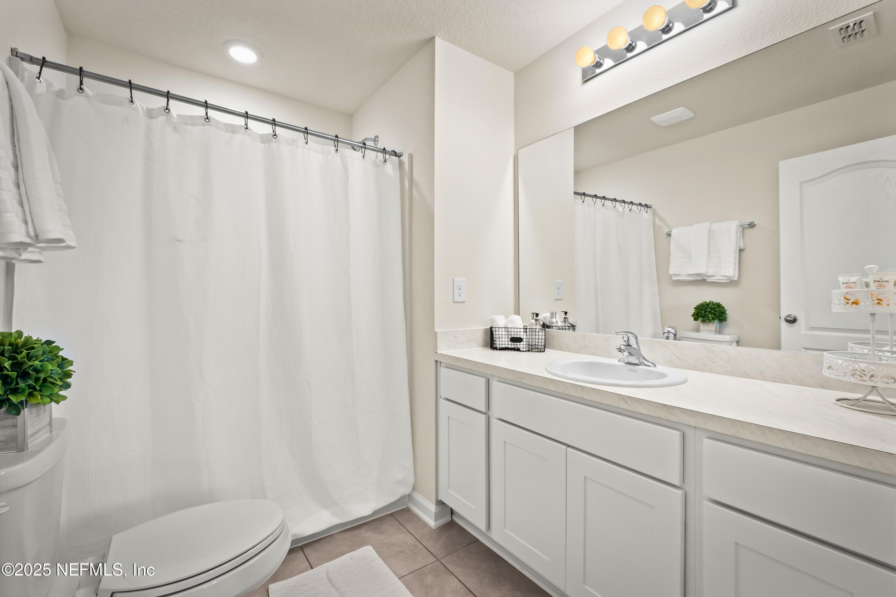 4920 Earthshine Road Jacksonville, FL 32256 - Photo 11 of 16 a bathroom with a sink a toilet and shower