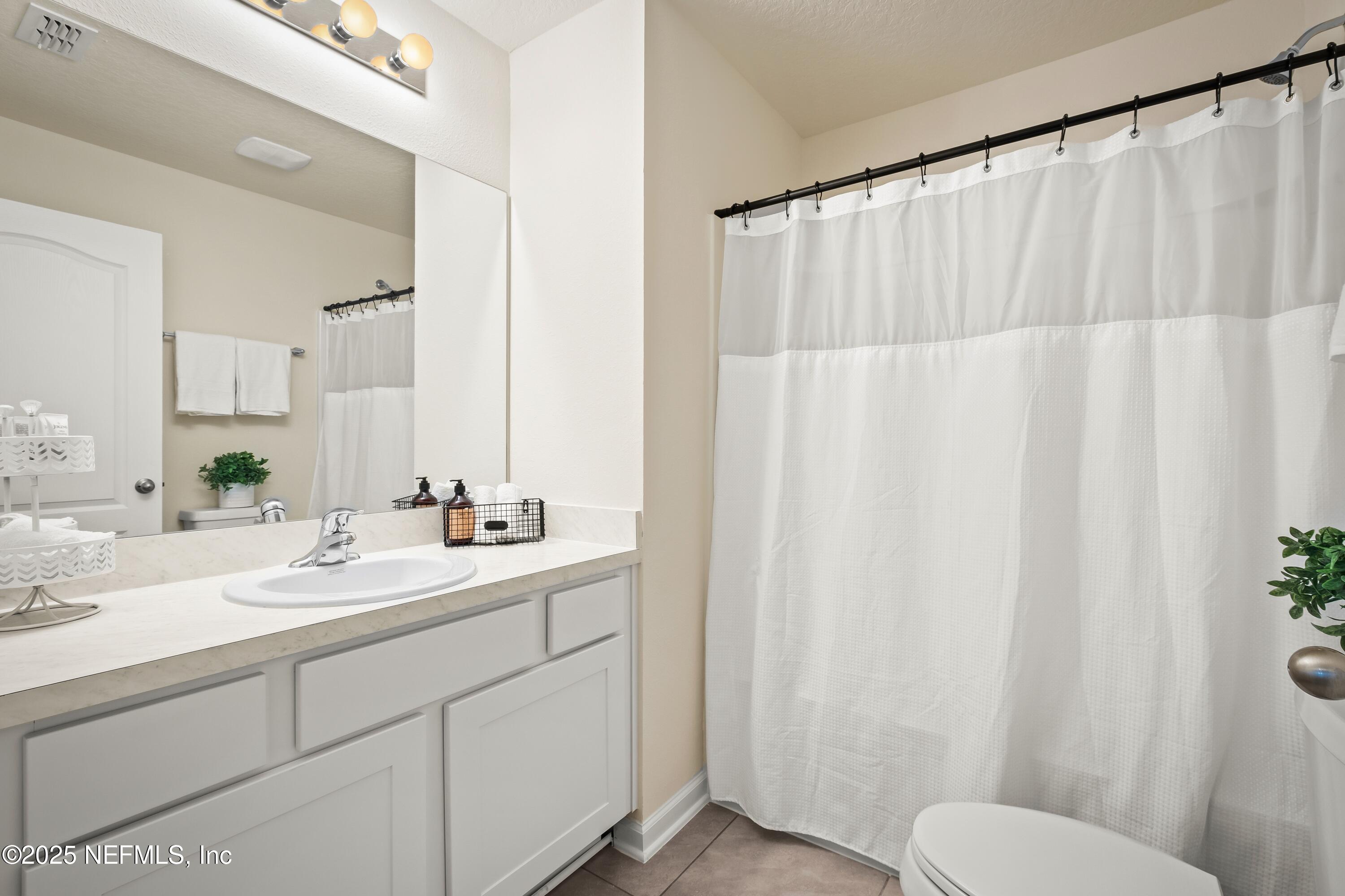 4920 Earthshine Road Jacksonville, FL 32256 - Photo 12 of 16 a bathroom with a sink and a mirror