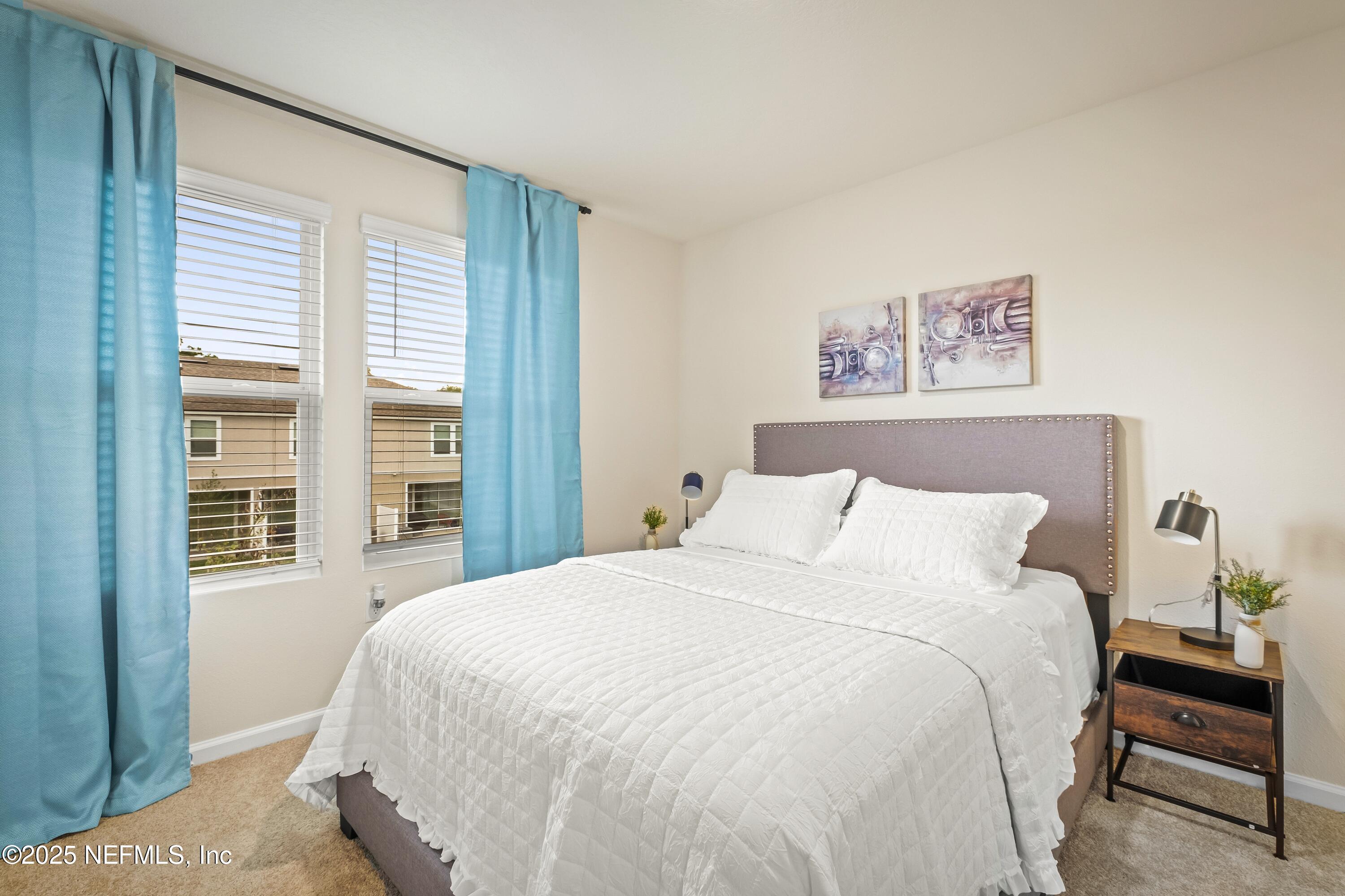 4920 Earthshine Road Jacksonville, FL 32256 - Photo 13 of 16 a bedroom with a large bed and a window