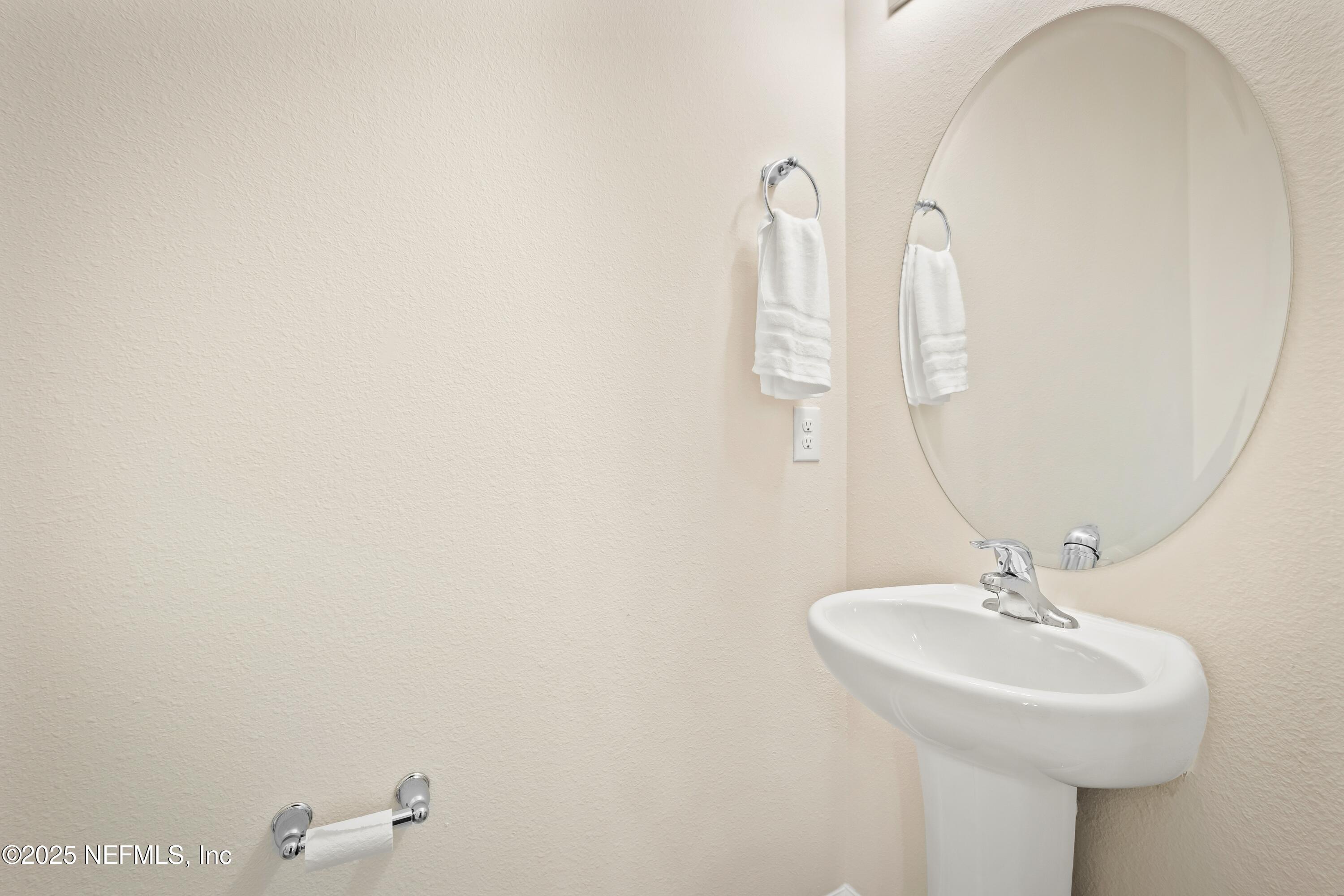 4920 Earthshine Road Jacksonville, FL 32256 - Photo 16 of 16 a bathroom with a sink and a mirror