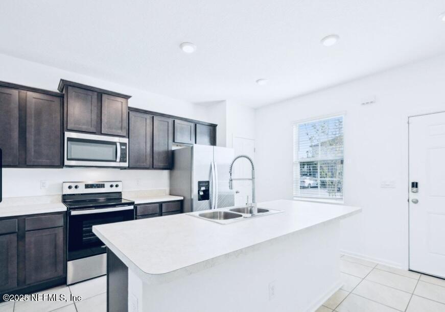 4920 Earthshine Road Jacksonville, FL 32256 - Photo 4 of 16 a kitchen with kitchen island a sink stove and refrigerator