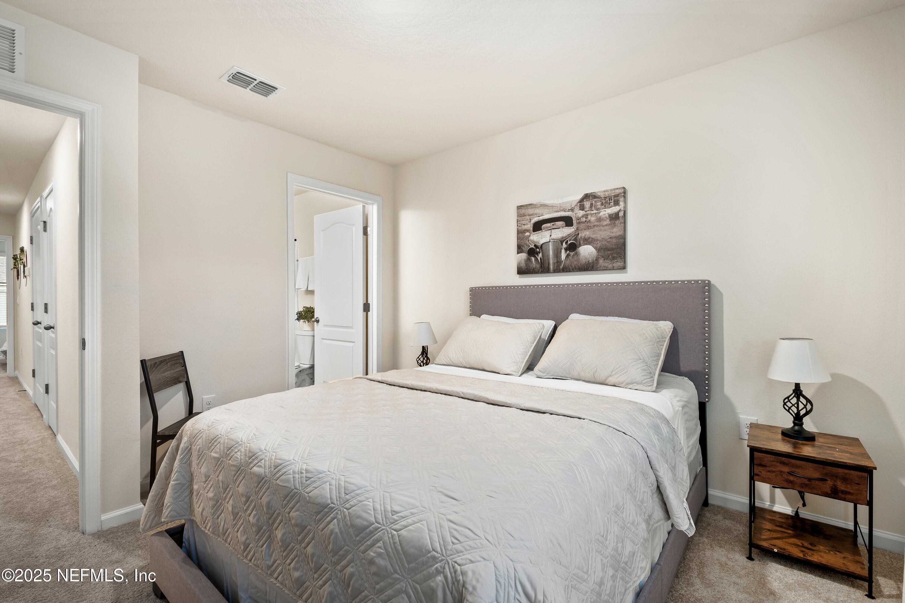 4920 Earthshine Road Jacksonville, FL 32256 - Photo 8 of 16 a bedroom with a bed and a painting on the wall