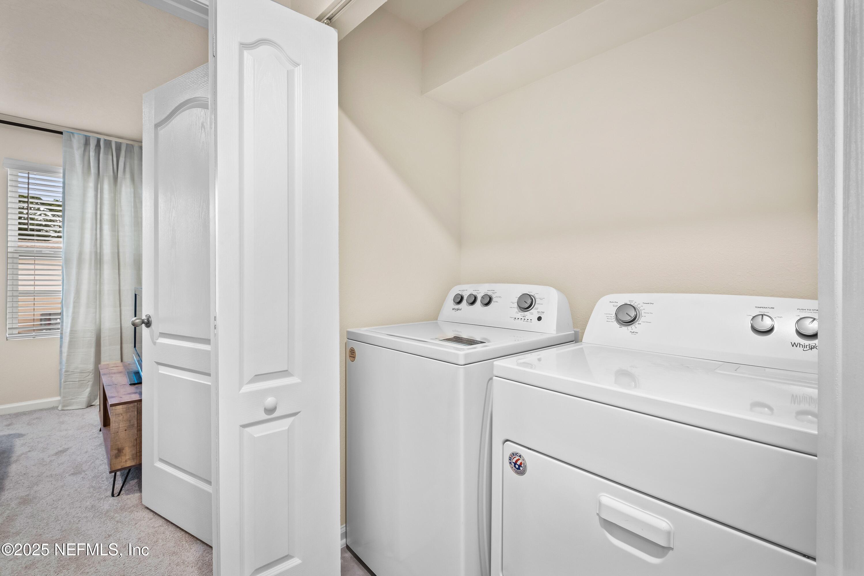 4920 Earthshine Road Jacksonville, FL 32256 - Photo 9 of 16 a view of washer and dryer with bathroom in the background