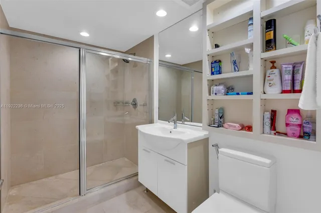 a bathroom with a sink toilet vanity and shower