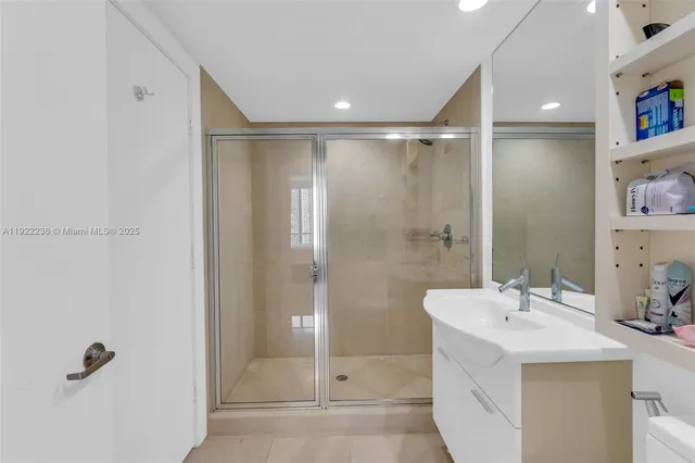 a bathroom with a shower sink and mirror