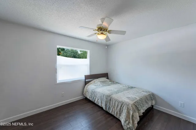 a bedroom with a bed a flat screen tv and balcony