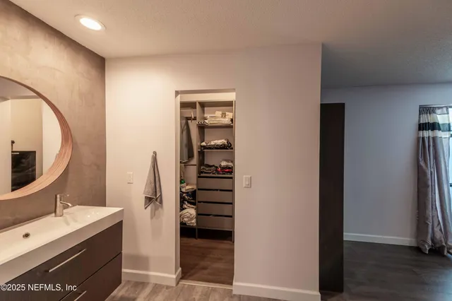 a kitchen with refrigerator and cabinets
