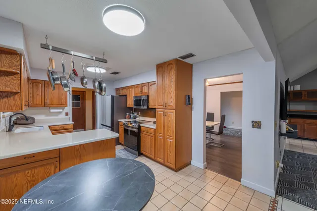 a kitchen with stainless steel appliances granite countertop a sink and cabinets