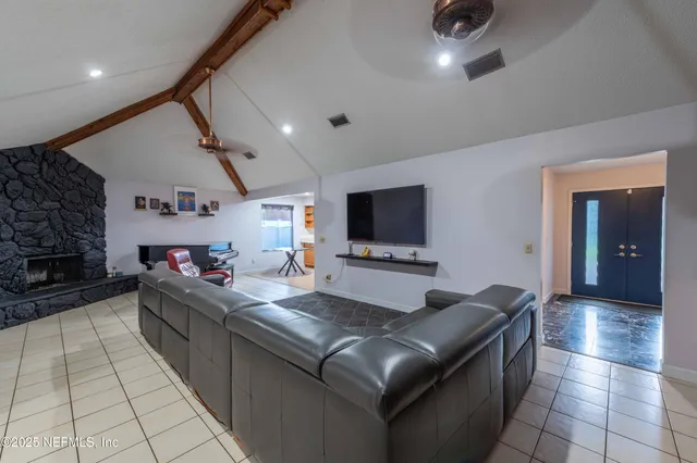 a view of a swimming pool with a patio and a yard