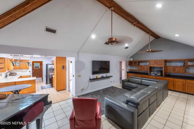 a backyard of a house with outdoor seating and barbeque oven