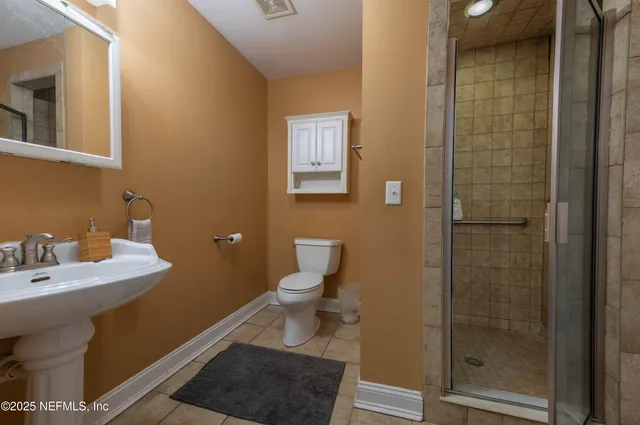 a view of a wooden bench sitting in a backyard