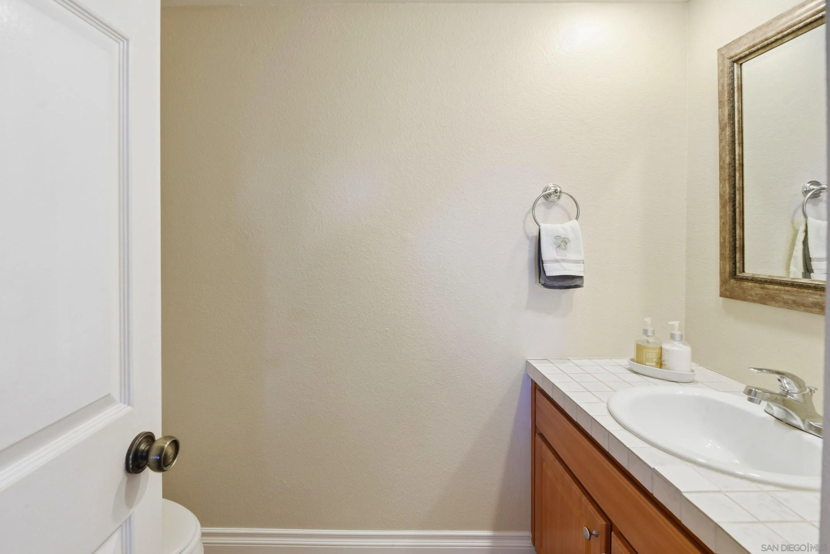 17443 Ashburton Road San Diego, CA 92128 - Photo 11 of 36 a bathroom with a sink and a mirror