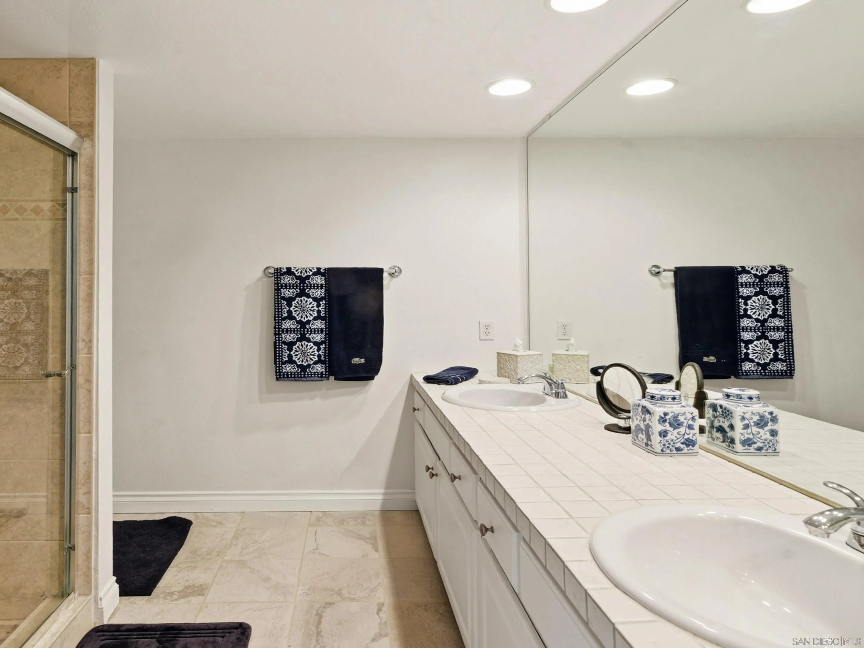 17443 Ashburton Road San Diego, CA 92128 - Photo 25 of 36 a bathroom with a double vanity sink and a mirror