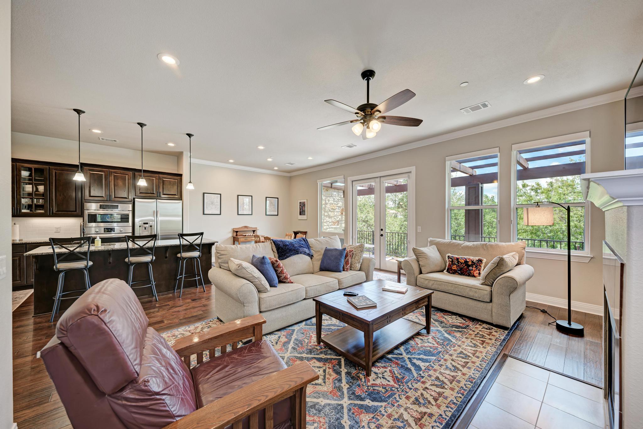 2601 North Quinlan Park Road, Unit 506 Austin, TX 78732 - Photo 11 of 39 An open-concept living area boasts a modern kitchen with a breakfast bar and spacious living room with abundant natural light.
